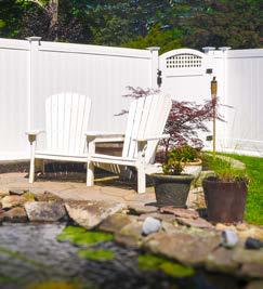 Illusions vinyl privacy fence with framed picket top in Classic White
